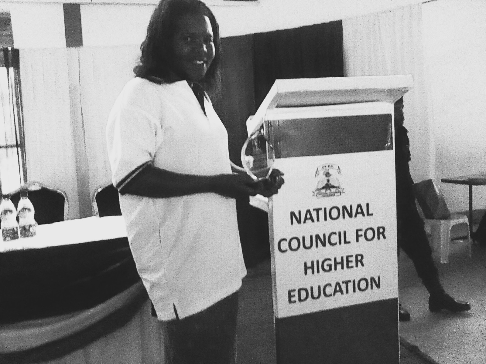 Maria receiving recognition for the University of Kisubi at the National Council for Higher Education Research and Innovation Exhibition, 2018.
