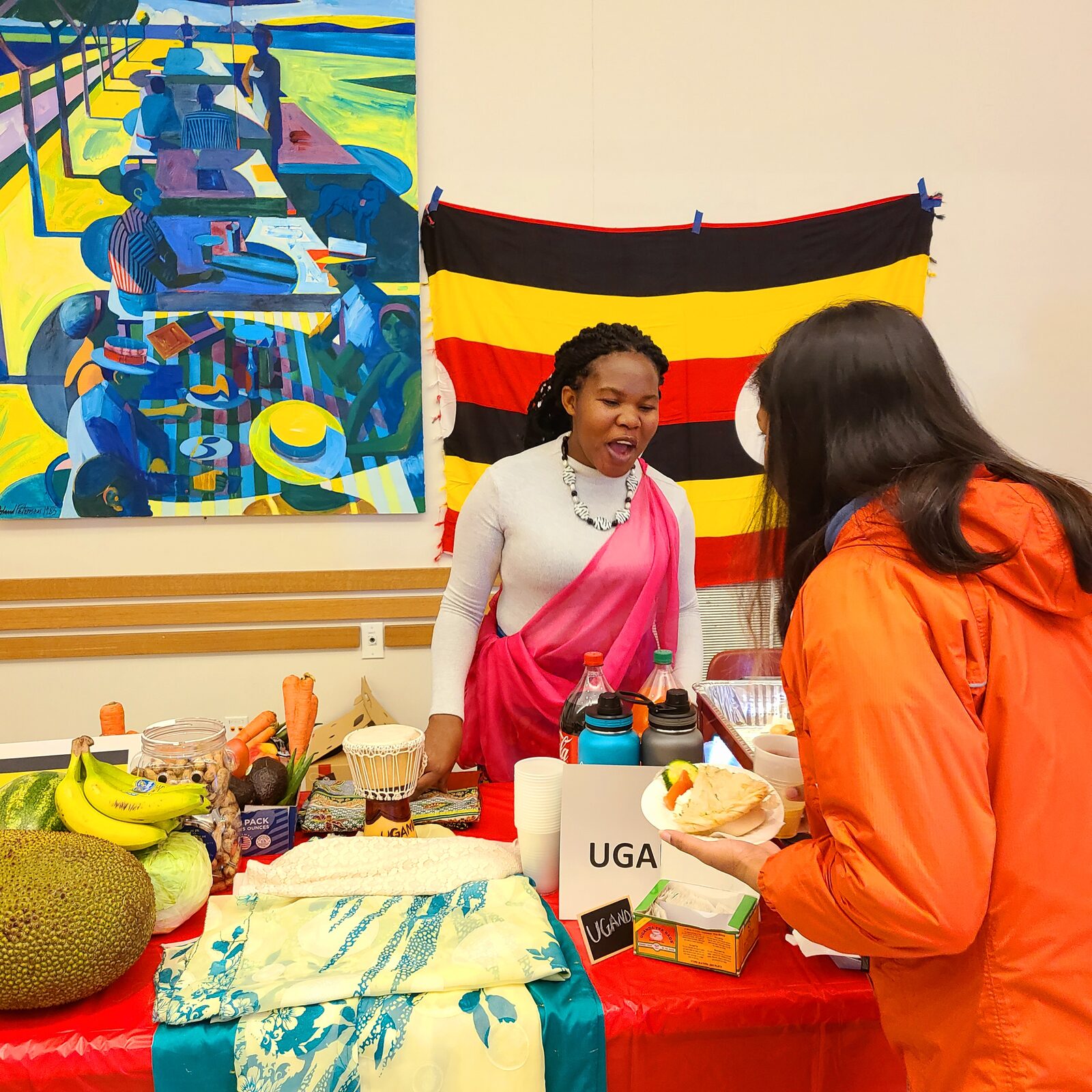 Maria sharing Ugandan culture at a cultural exhibit, February 2023.