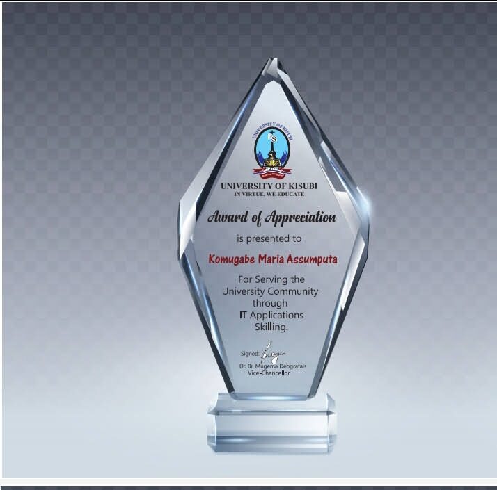 Maria receiving the University of Kisubi Award of Appreciation for IT skilling service.