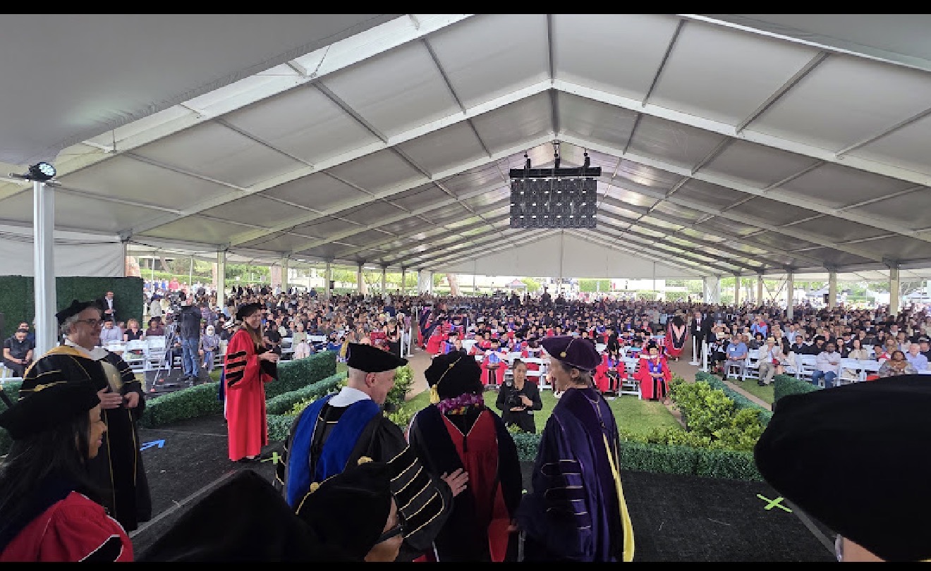 Maria celebrating the conferral of her Ph.D. at Claremont Graduate University Commencement, May 16, 2026.