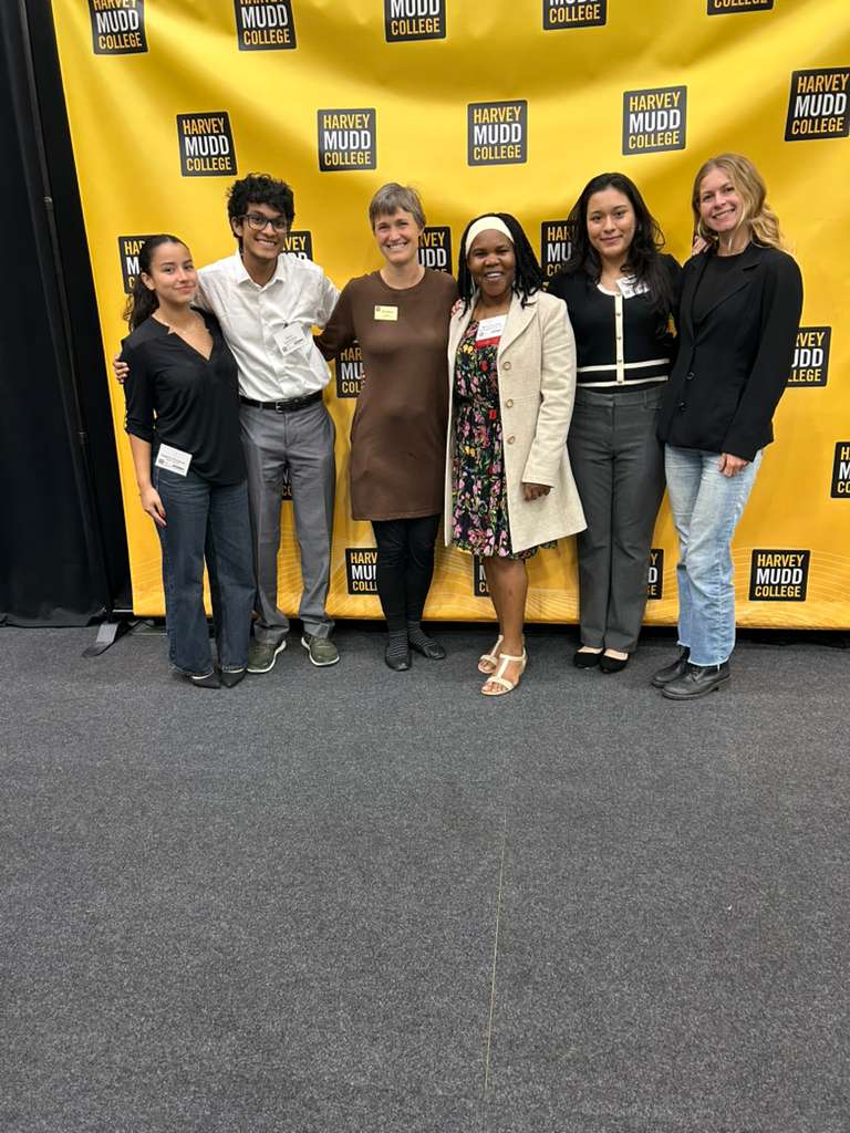 Maria representing Musizi at Harvey Mudd College Clinic Day in 2026, celebrating the project with the student team and collaborators.